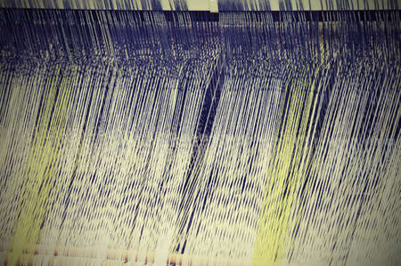 antique frame for weaving yarns with colored threads with vintage effectの写真素材