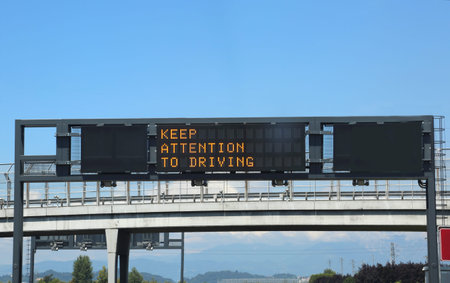 orange highway signs of attention to driving