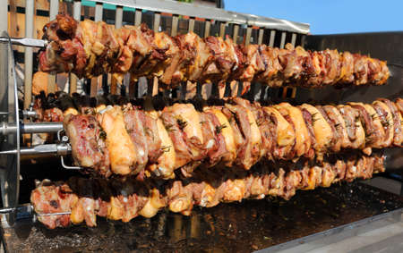 big spit with many skewers full of chicken meat and porkのeditorial素材