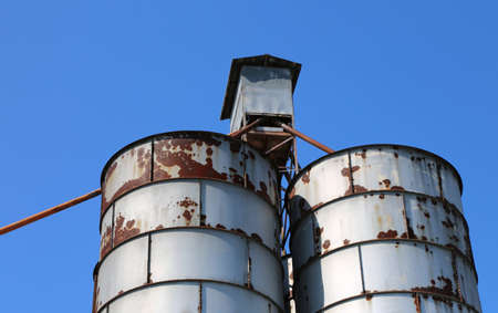 old abandoned metal silos used once to contain animal feedの写真素材