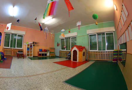 wide hall of a kindergarten with many toys and whitout childrenの写真素材