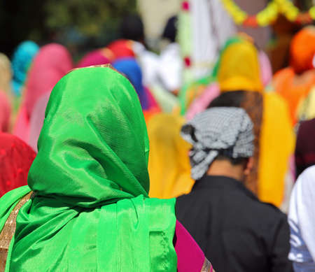 woman with veil on head during religious sikh procession outdoorsの写真素材