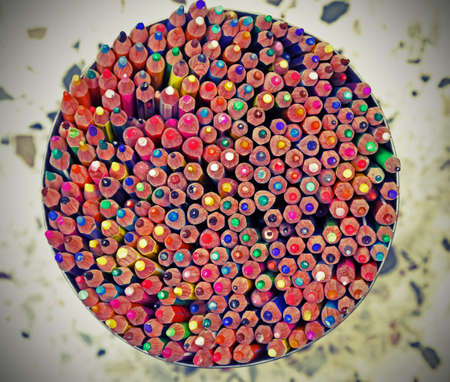 background of colored wooden pencils with the tip of many colors inside a circular tin and vintage effectの写真素材