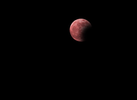 visible lunar eclipse with the big red full moon in the dark night