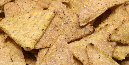 background of many triangles of Tortillas chips a very good salty snack
