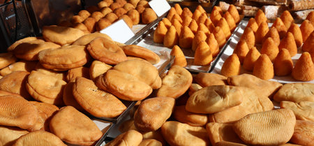 typical Italian food called Panzerotti  made with tomato and mozzarella cheese and Arancini maed...
