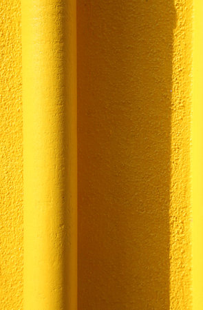 yellow gutter on the yellow wall of an house