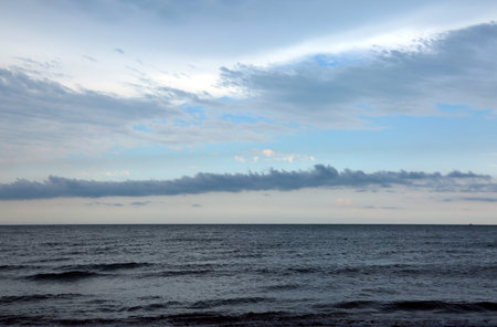 landscape with sea and white and dark clouds before the stormの写真素材