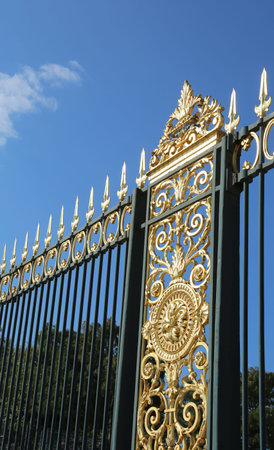 european ancient golden gate and blue sky in backgroundの写真素材