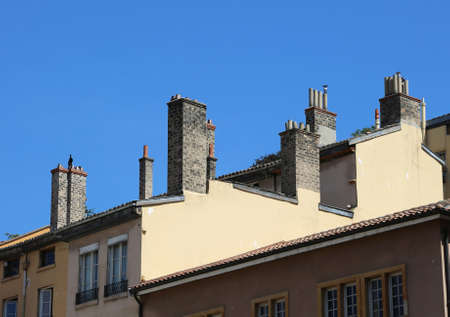 typical French style chimneys above the roof of the European houseの写真素材