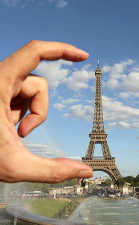 hand performing the measurement of the Eiffel Tower in Paris in Franceの写真素材