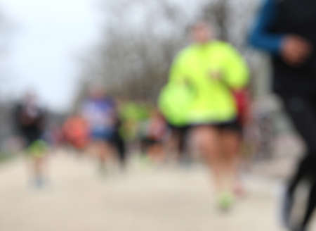 foot race with unrecognizable runners and INTENTIONALLY BLURRED to use as a backgroundの写真素材