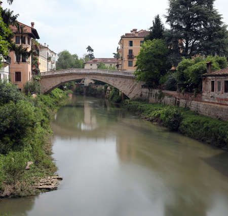 Italian river called Retrone in Vicenza City in Italy and the ancient Bridge of Saint Michaelの写真素材