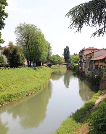 Bacchiglione river in Vicenza Town in Northern Italy and the bridge in backgroundの写真素材