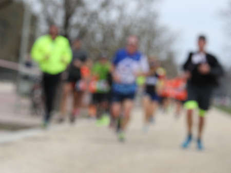 foot race with many unrecognizable runners and INTENTIONALLY BLURRED to use as a backgroundの写真素材