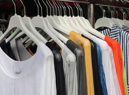 stand of clothes for sale at outdoor market in summerの写真素材