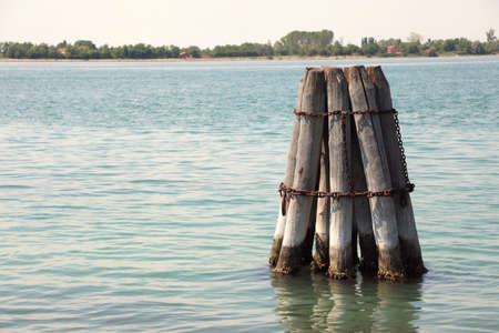 big dophin made with trunks to moor the boat on Venetian Lagoon near Venice Islandの写真素材
