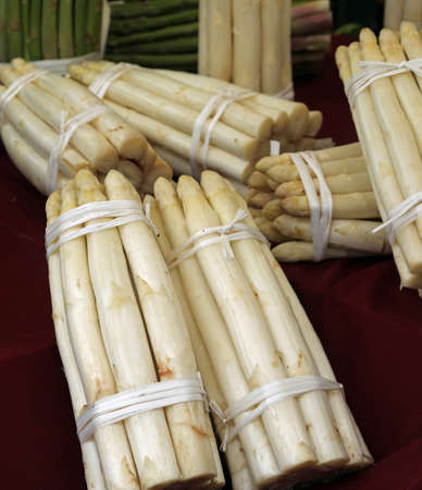 bunches white asparagus for sale at the fruit and vegetable marketの写真素材