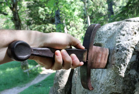 hand of man and the sword in the stone such as the famous legend of King arthurの写真素材