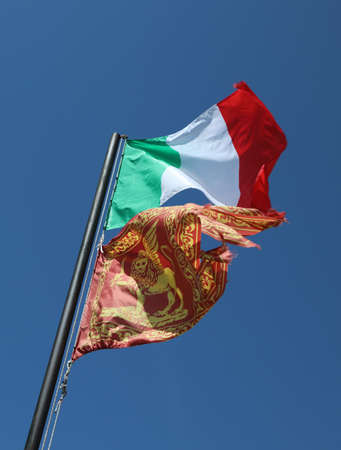 Italian flag and the Flag of Venetian al so called Bandiera del Veneto with winged lion of Saint Markの写真素材