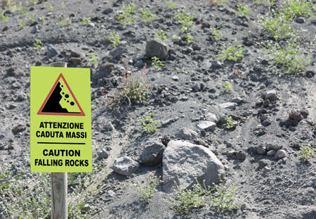 Warning Signal on the slope of Volcano with text in English and Italian Language Caution falling rocks and lavasの写真素材