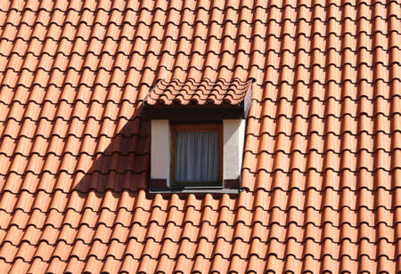 roof with tiles and a window called dormer in an european cityの写真素材