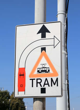 big road sign with attention signs of crossing tram tracks in the metropolitan cityの写真素材
