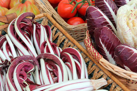greengrocery shop with organic vegetables on the basketの写真素材