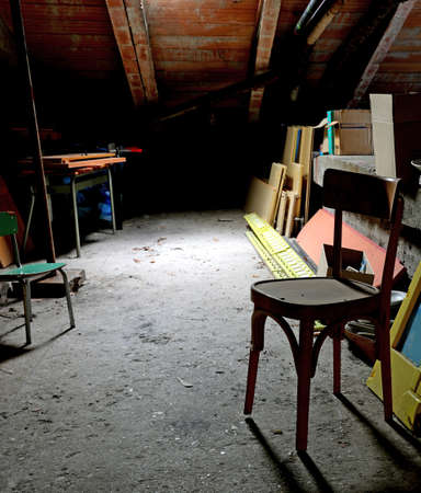 very dust and dirty attic with many abandoned itemsの写真素材