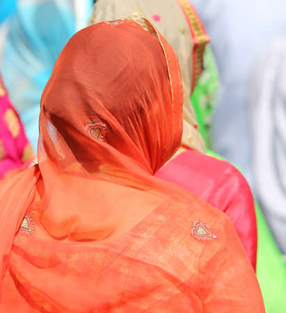 women with head covered by a veil during a paradeの写真素材