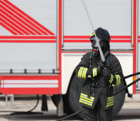 fireman with hose hydrant in action
