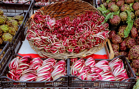 red chicory called RADICCHIO TARDIVO in Italian language for sale in the greengrocer stall at the...
