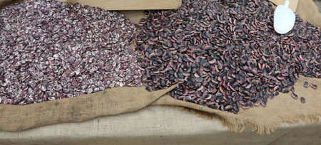many beans of various qualities for sale in the greengrocer stall at the local market
