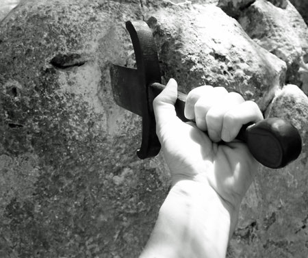 Sword in the stone and the hand of king with black and white effect