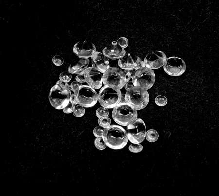 many rough diamonds on a black background in the jewelers shopの写真素材