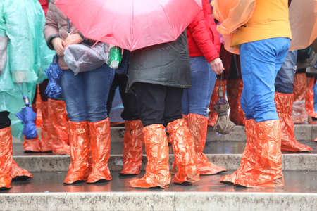 many people with special waterproof gaiters on the steps of the bridge in Venice during the rainの写真素材