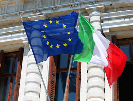 Big European flag and Italian flag in the facade of Palaceの写真素材