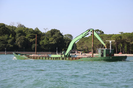 industrial big crane at boat on the sea
