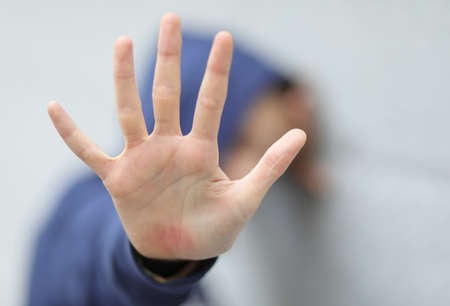 hand of the little girl who tries to protect herself from her attacker during the domestic disputeの写真素材