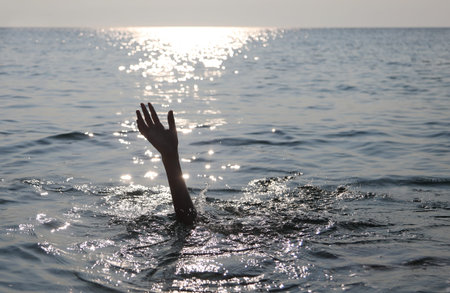 hand of a drowned person on the sea