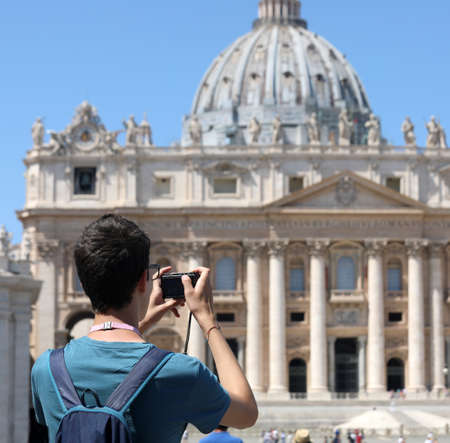 photographer while taking a picture at Square of Saint Peter with Basilica in the VATICAN city in Central Italy in summerの写真素材