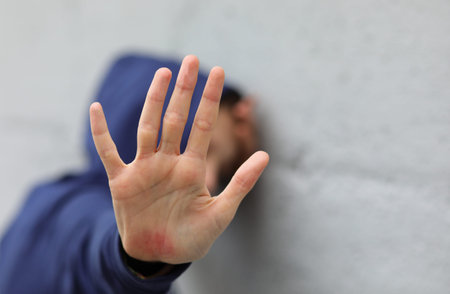 hand of little girl protecting herself to avoid domestic violenceの写真素材