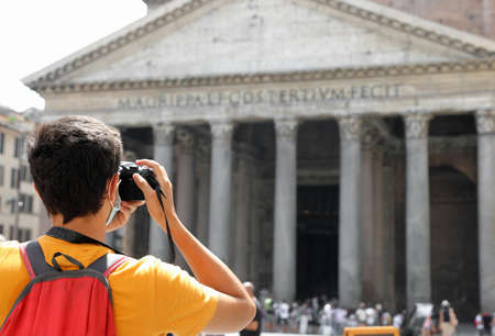 young tourist photographer caught souvenir photos at the great ancient temple of the Pantheon in Rome capital of Italyの写真素材