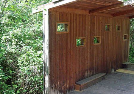 small shed built with wood to see birds or to use for hunting purposesの写真素材