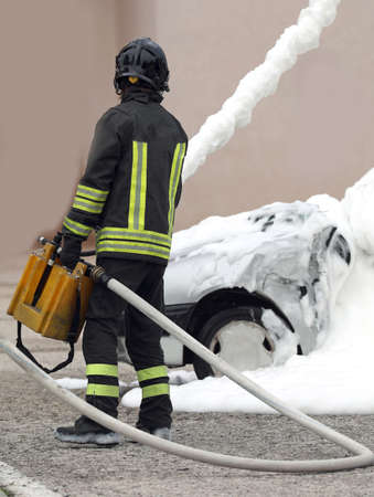 fire brigade team in action while extinguishing the fire after the car accidentの写真素材