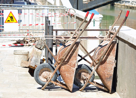 Two wheelbarrows in the construction site without people