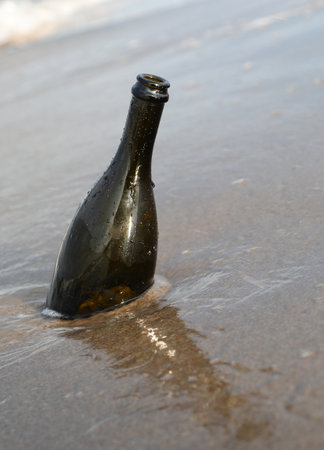 beached glass bottle that can hold a secret message or the treasure map by the seaの写真素材