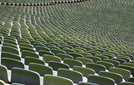 thousands of empty green seats in a sports facility without peopleの写真素材