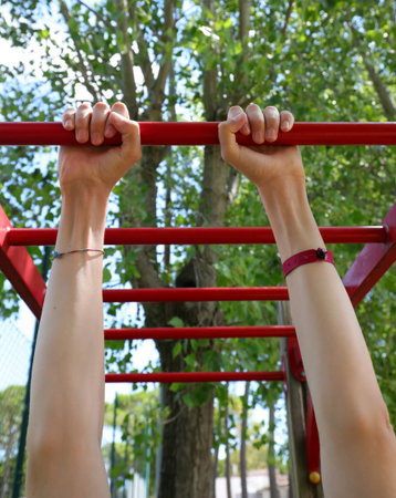 athlete s hands training at the bars during a physical exercise