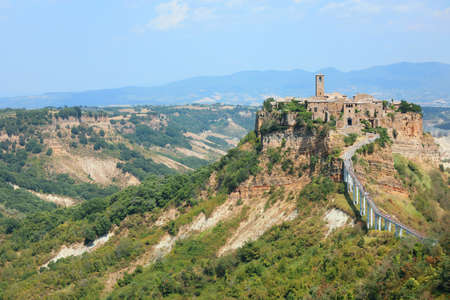 Civita di Bagno Regio, VT, Italy - August 16, 2020: incredible small village perched above the hill reachable only through a long pedestrian bridge and the valley aroundのeditorial素材